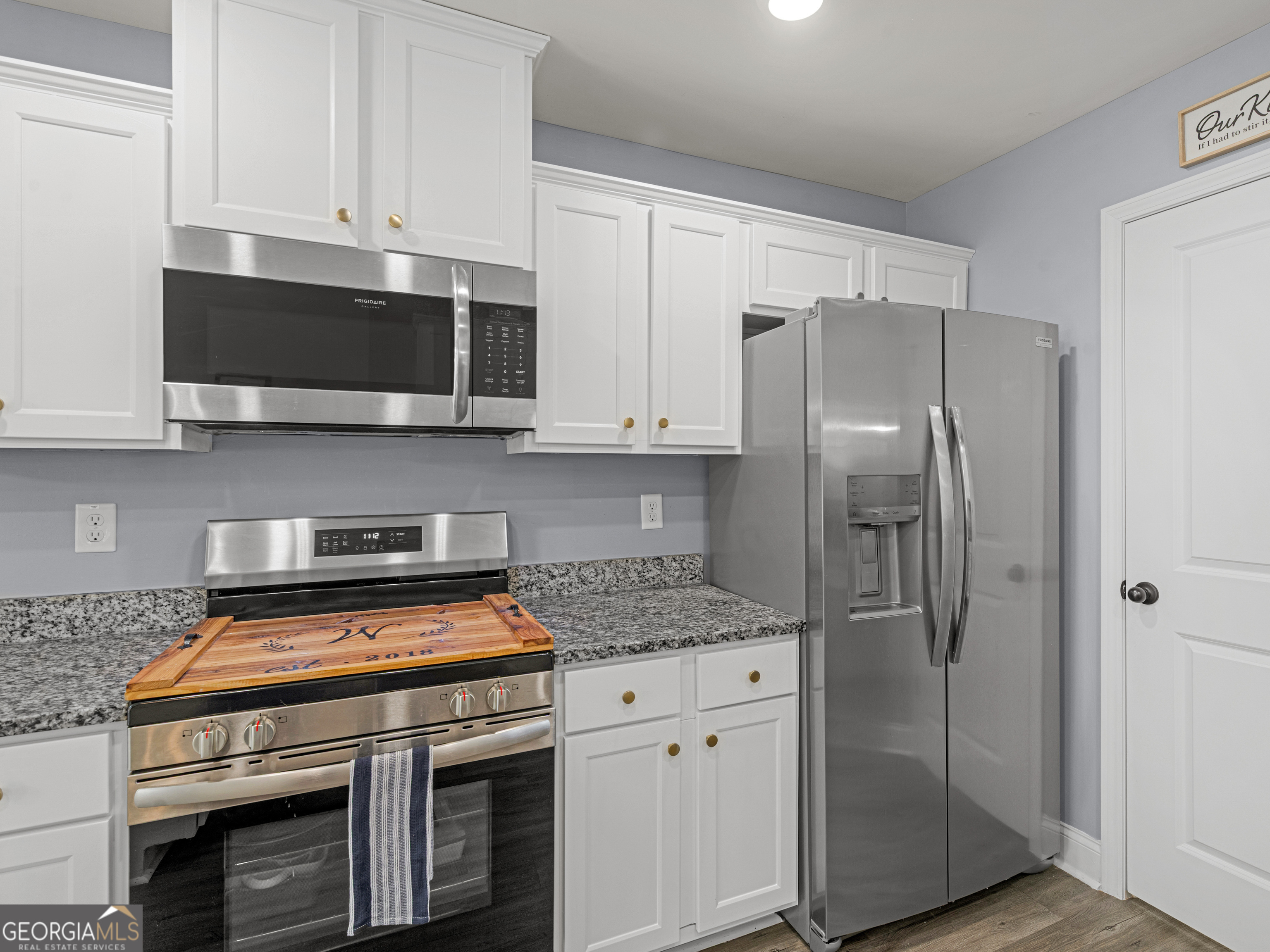 119 Mylee Cove Barnesville, GA 30204 - Photo 26 of 57 a kitchen with stainless steel appliances granite countertop a stove a refrigerator and a microwave