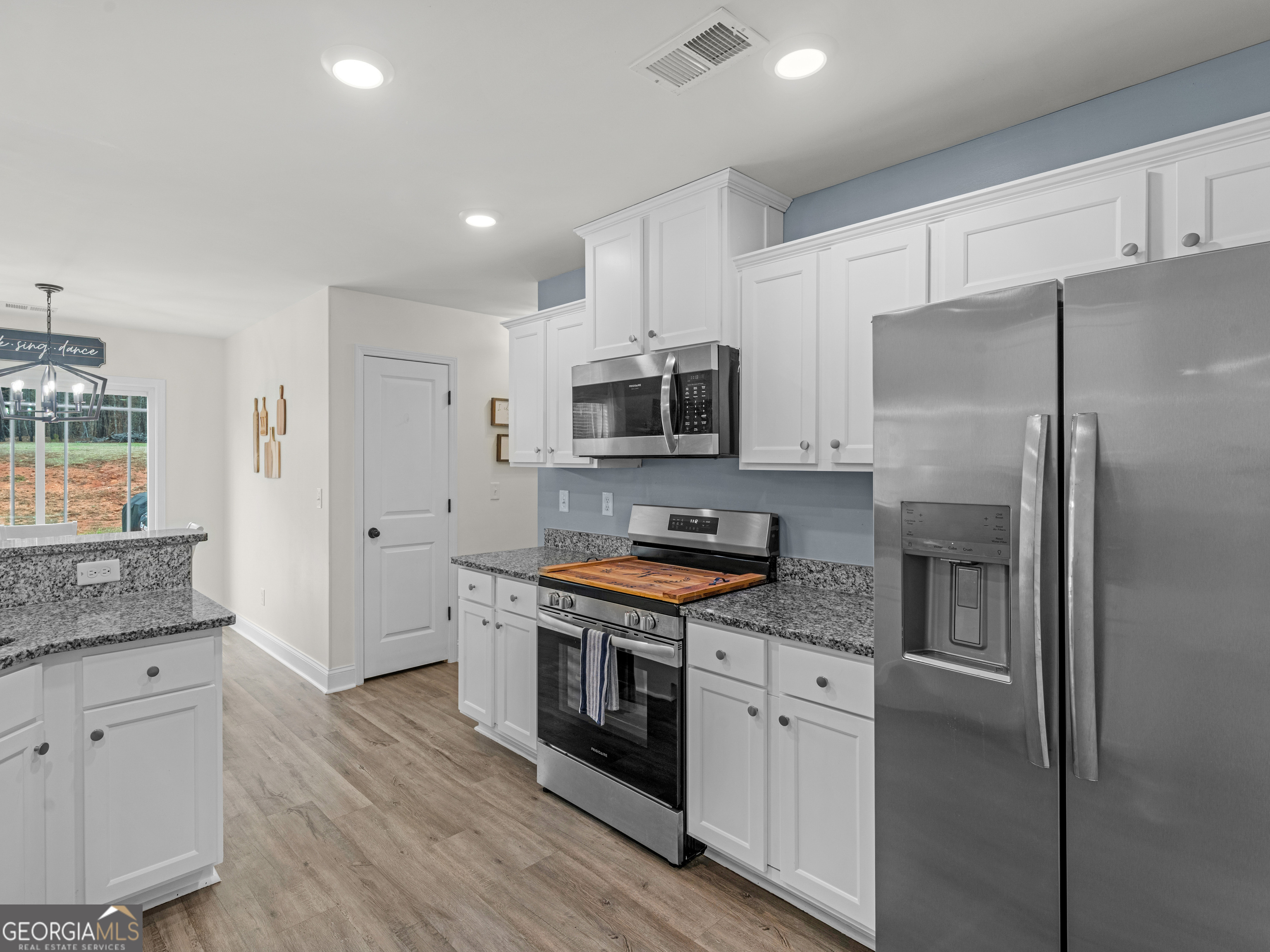 119 Mylee Cove Barnesville, GA 30204 - Photo 27 of 57 a kitchen with stainless steel appliances granite countertop a refrigerator and a stove top oven