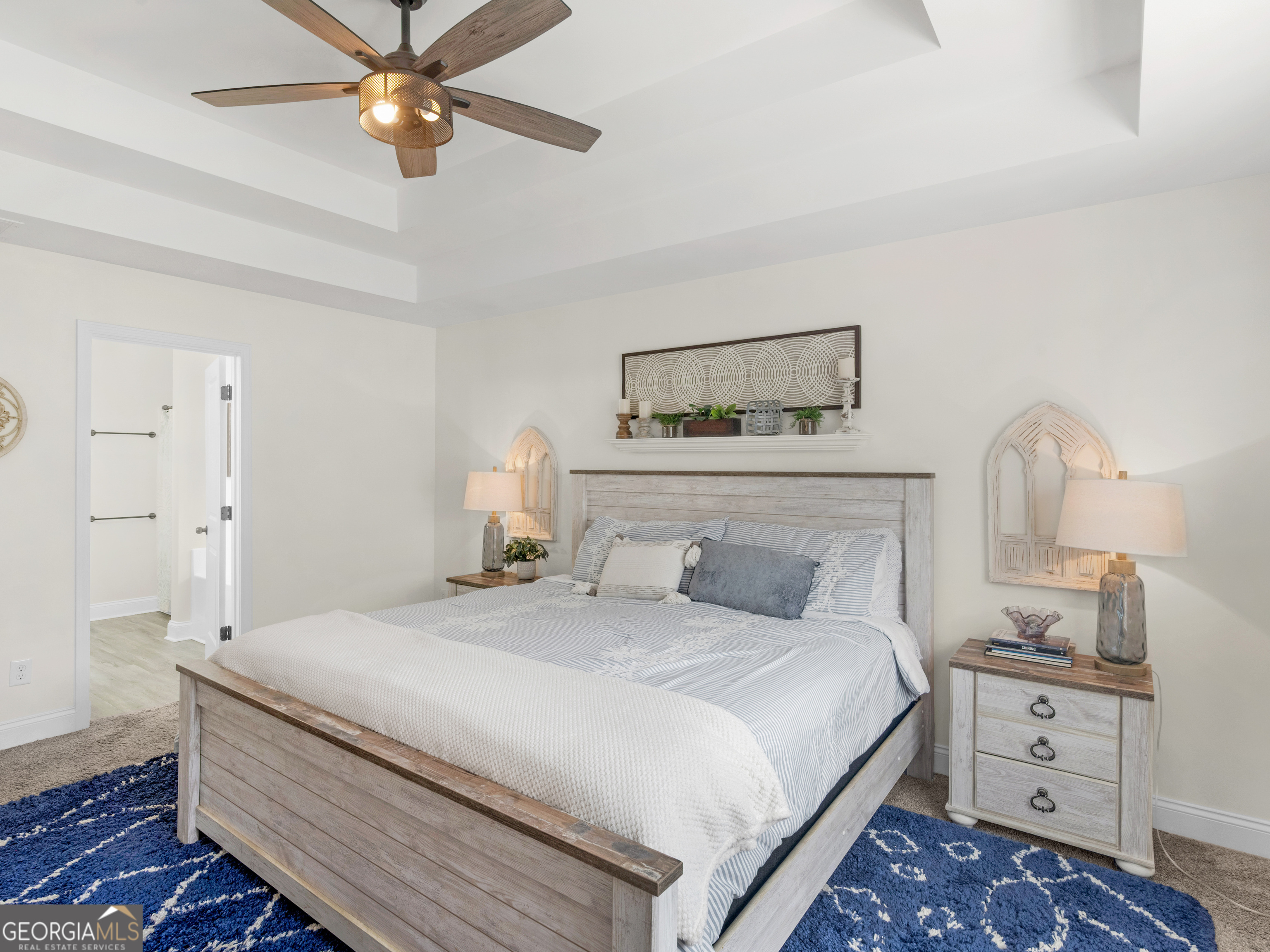 119 Mylee Cove Barnesville, GA 30204 - Photo 31 of 57 a bedroom with a bed and a chandelier