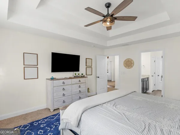 a bathroom with a granite countertop double vanity sink and a mirror