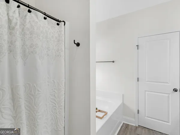 a bedroom with a bed a large window and book self