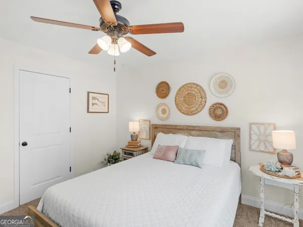 a bedroom with a large bed and a large window