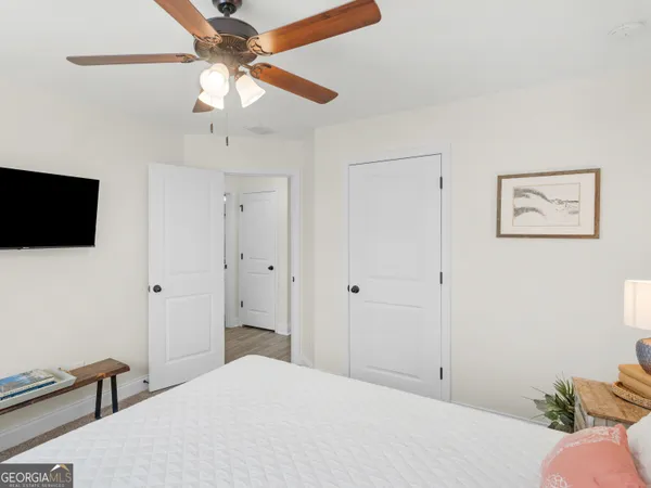 a bathroom with a granite countertop sink a mirror and shower