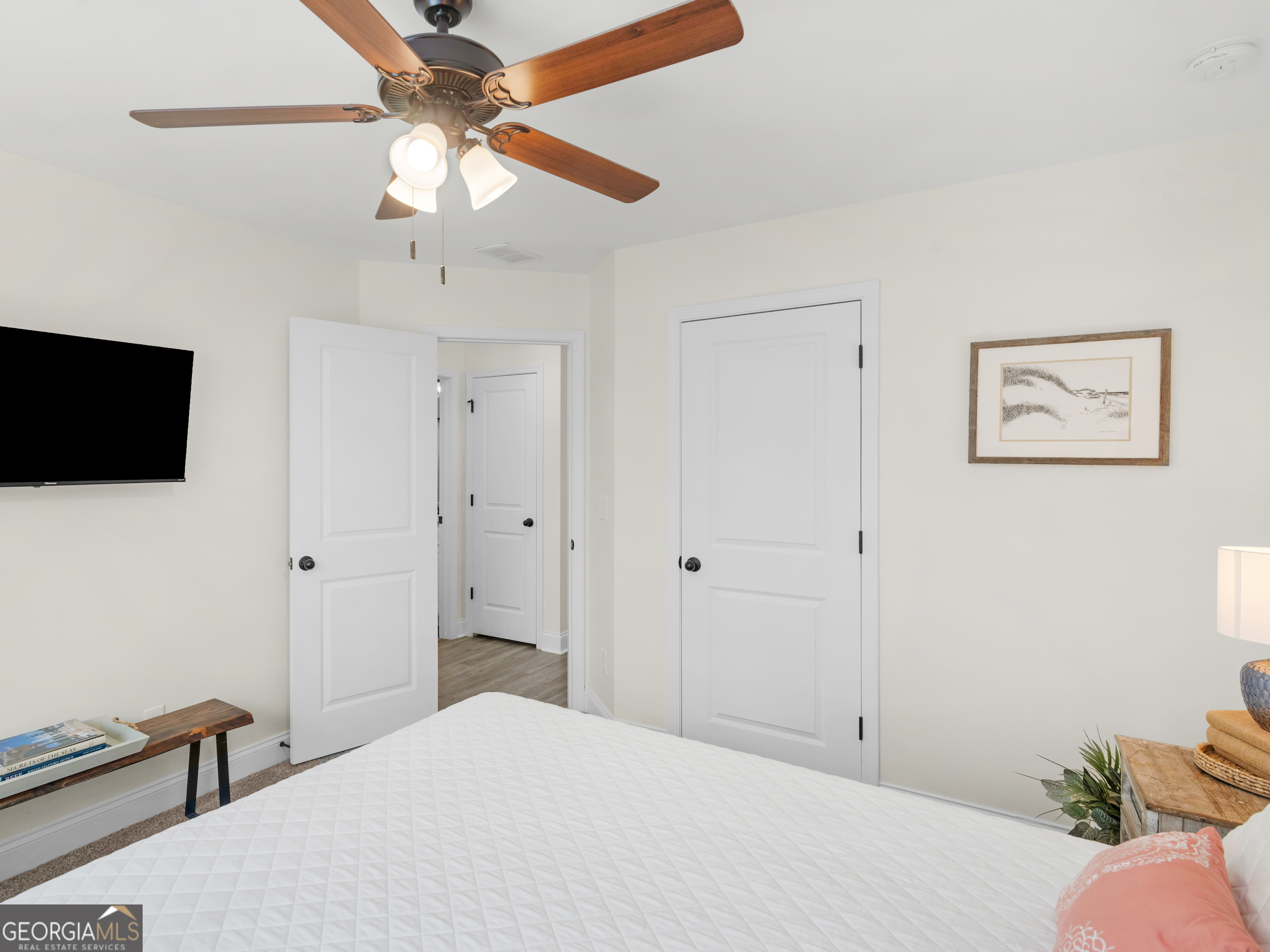 119 Mylee Cove Barnesville, GA 30204 - Photo 39 of 57 a bedroom with a bed and a flat screen tv