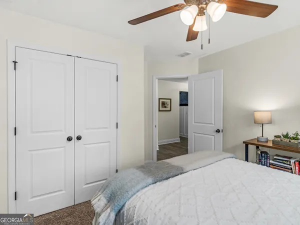 an empty room with a window and a fan