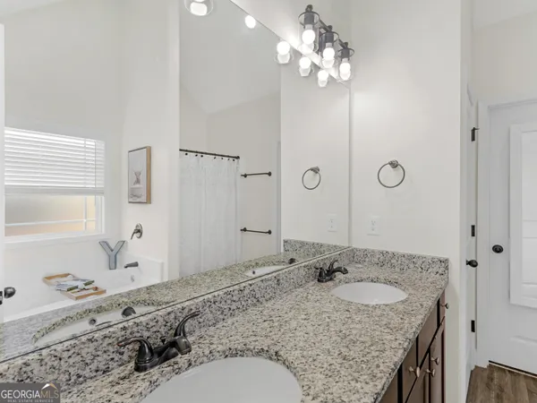 an empty room with a ceiling fan and a window