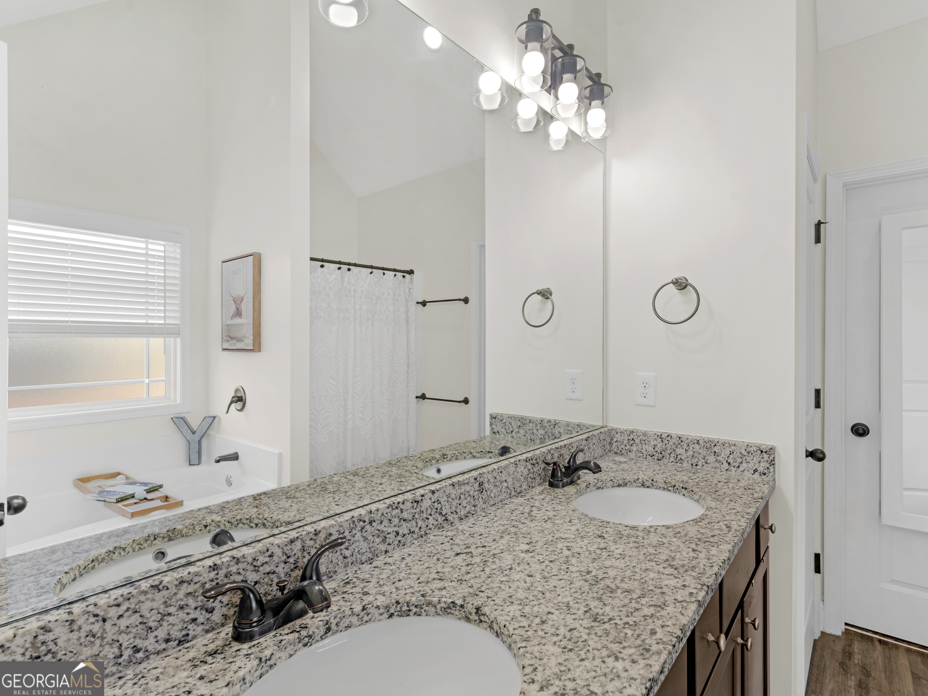 119 Mylee Cove Barnesville, GA 30204 - Photo 44 of 57 a bathroom with a granite countertop sink a mirror and shower