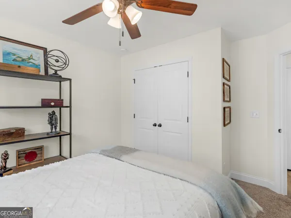 a bathroom with a granite countertop sink a toilet and a mirror