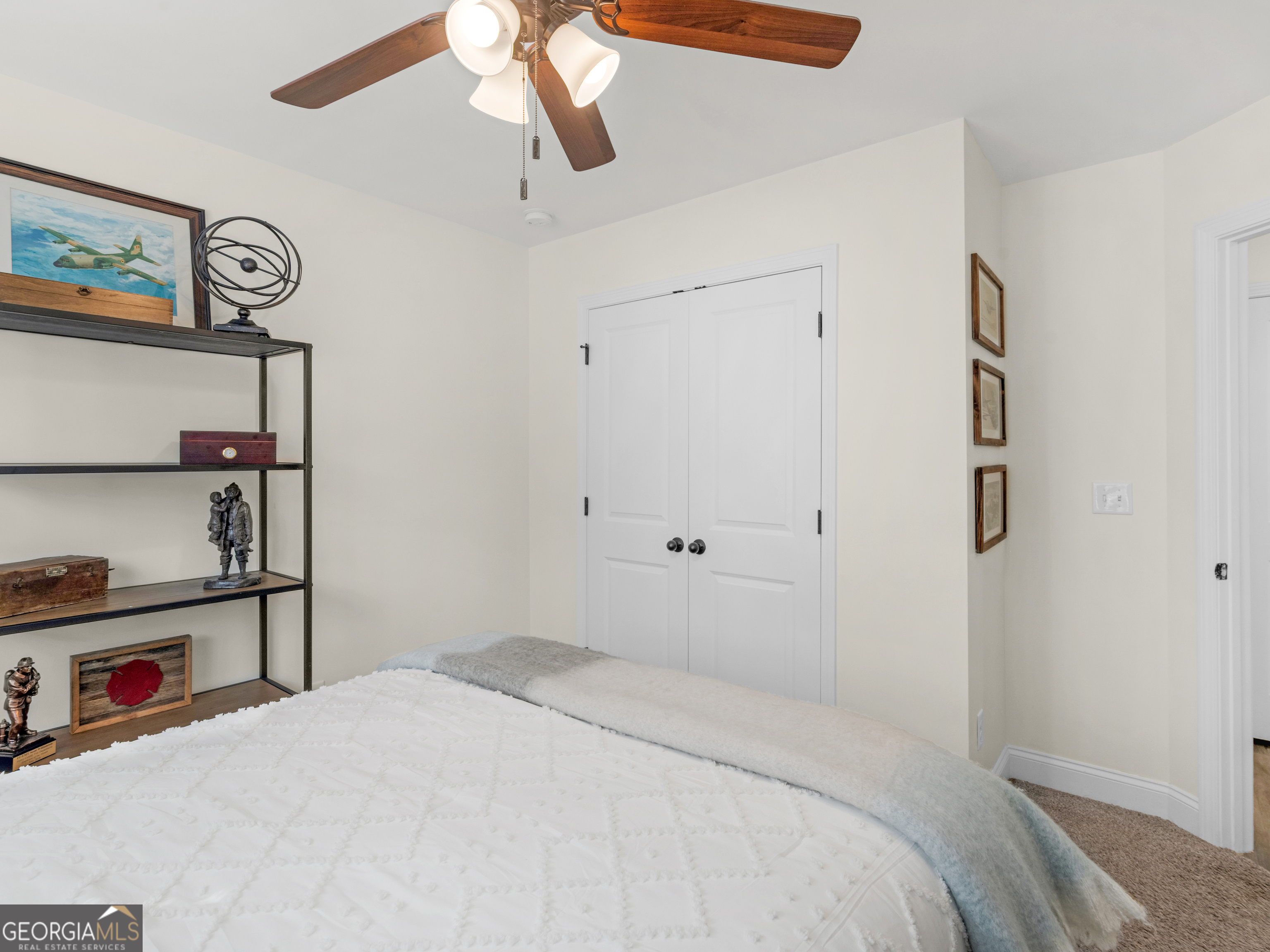 119 Mylee Cove Barnesville, GA 30204 - Photo 45 of 57 a bedroom with a bed and a chandelier