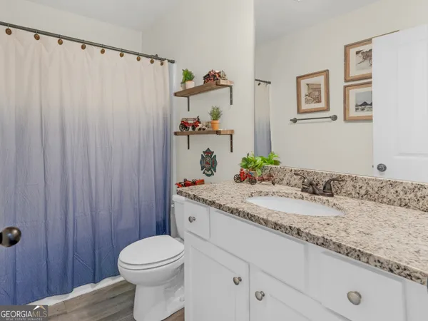 a blue swimming pool with outdoor seating and yard