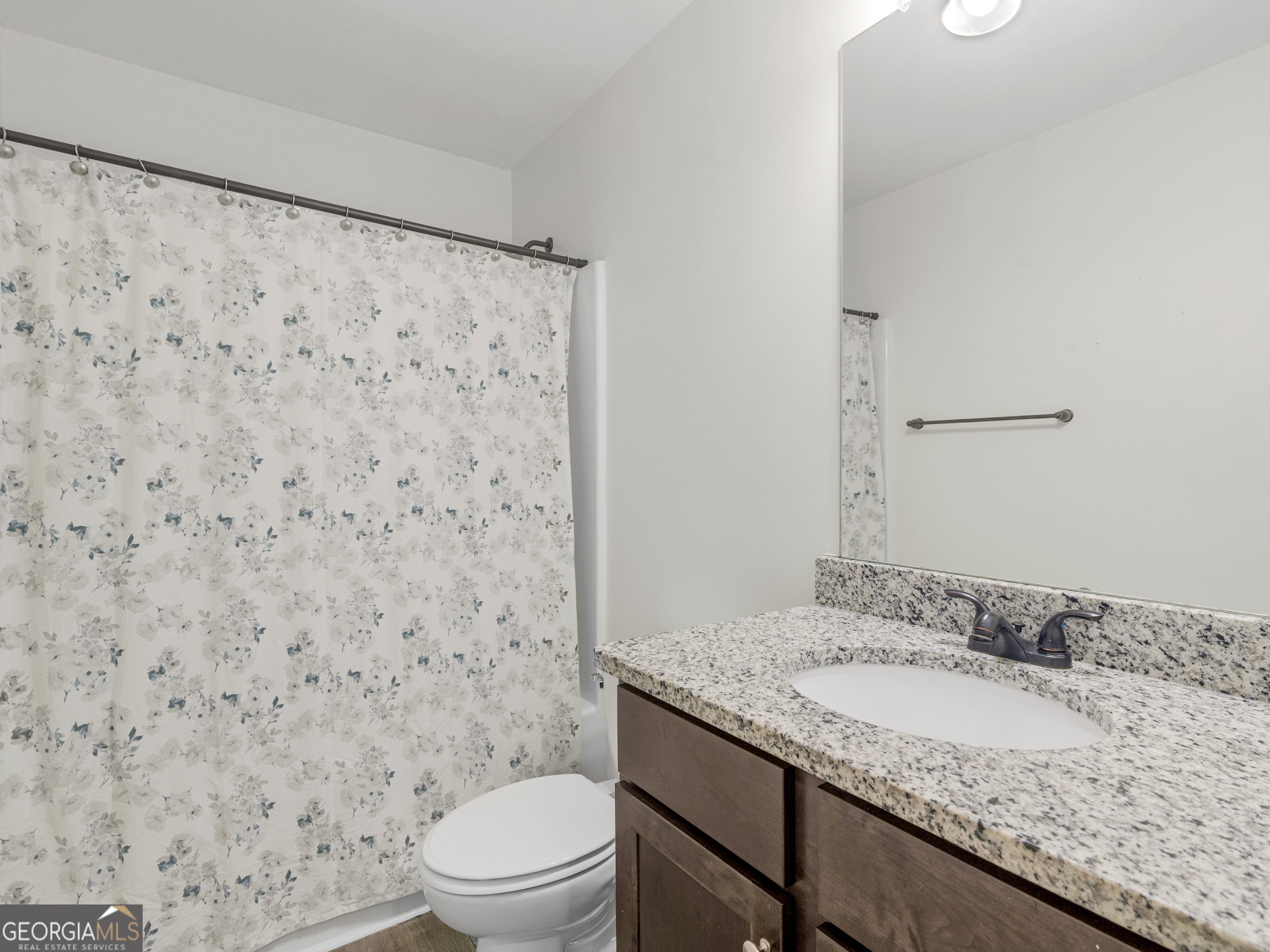 119 Mylee Cove Barnesville, GA 30204 - Photo 51 of 57 a bathroom with a granite countertop sink a toilet and a mirror