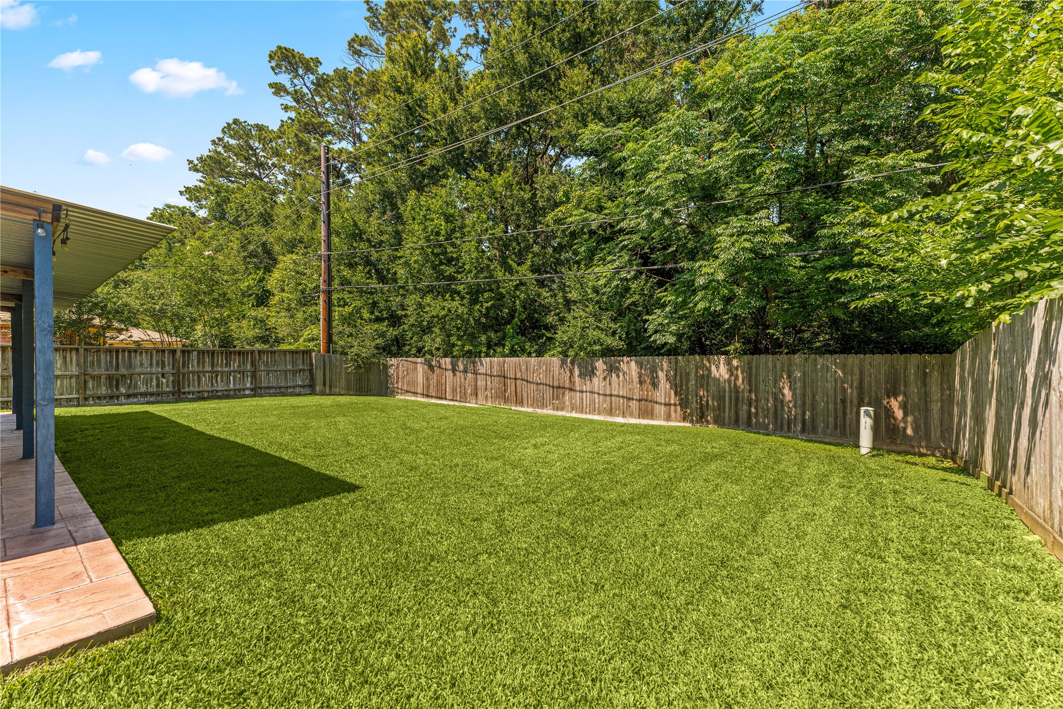 19726 Teller Boulevard Spring, TX 77388 - Photo 21 of 24 Enjoy your own private sanctuary in this sprawling, sun-filled backyard. The meticulously maintained lawn offers endless space for play, gardening, or future additions like a pool or fire pit. Fully enclosed by a sturdy privacy fence and bordered by mature trees, this tranquil outdoor space provides a peaceful escape from the hustle and bustle of daily life.