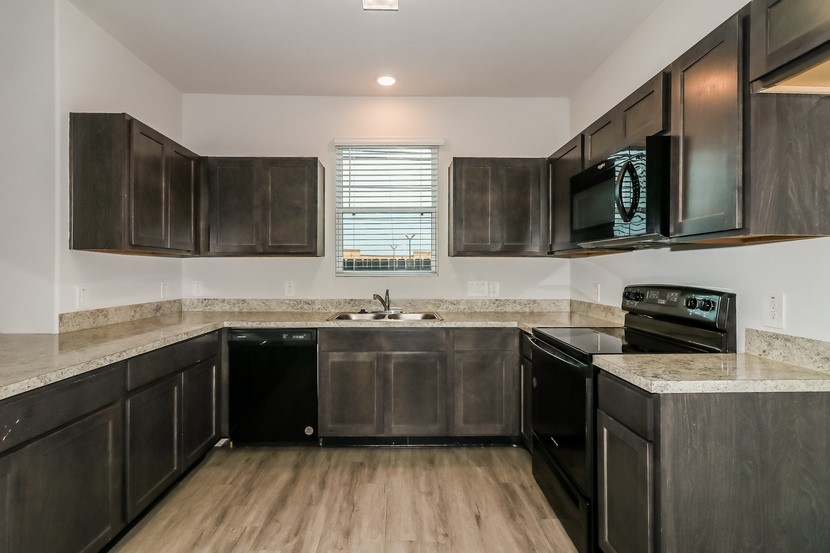 21626 Mamba Way Houston, TX 77073 - Photo 2 of 12 a kitchen with a sink stove top oven and cabinets