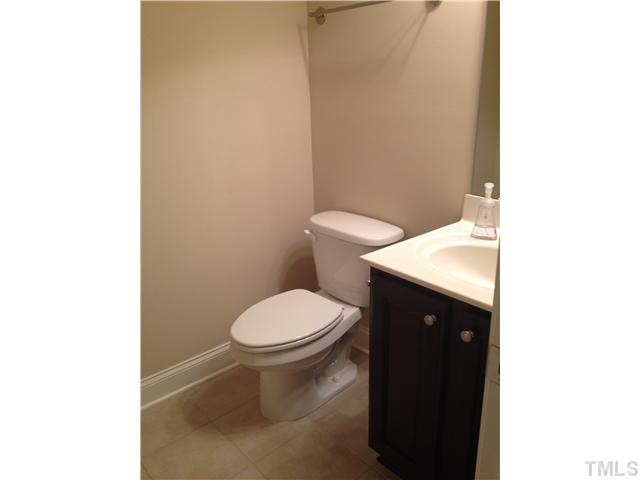 3614 Silver Forrest Lane Raleigh, NC 27614 - Photo 24 of 25 The third floor half bath has a tile floor and dark wood vanity. Half Bath