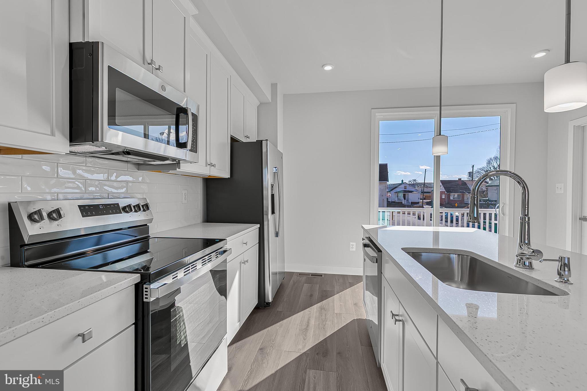 1 E Oasis Avenue Ranson, WV 25438 - Photo 11 of 38 a kitchen with a sink stove and refrigerator