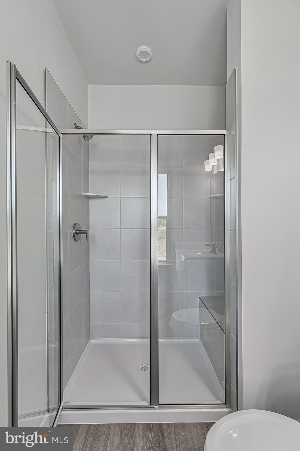 1 E Oasis Avenue Ranson, WV 25438 - Photo 36 of 38 a bathroom with a glass shower door