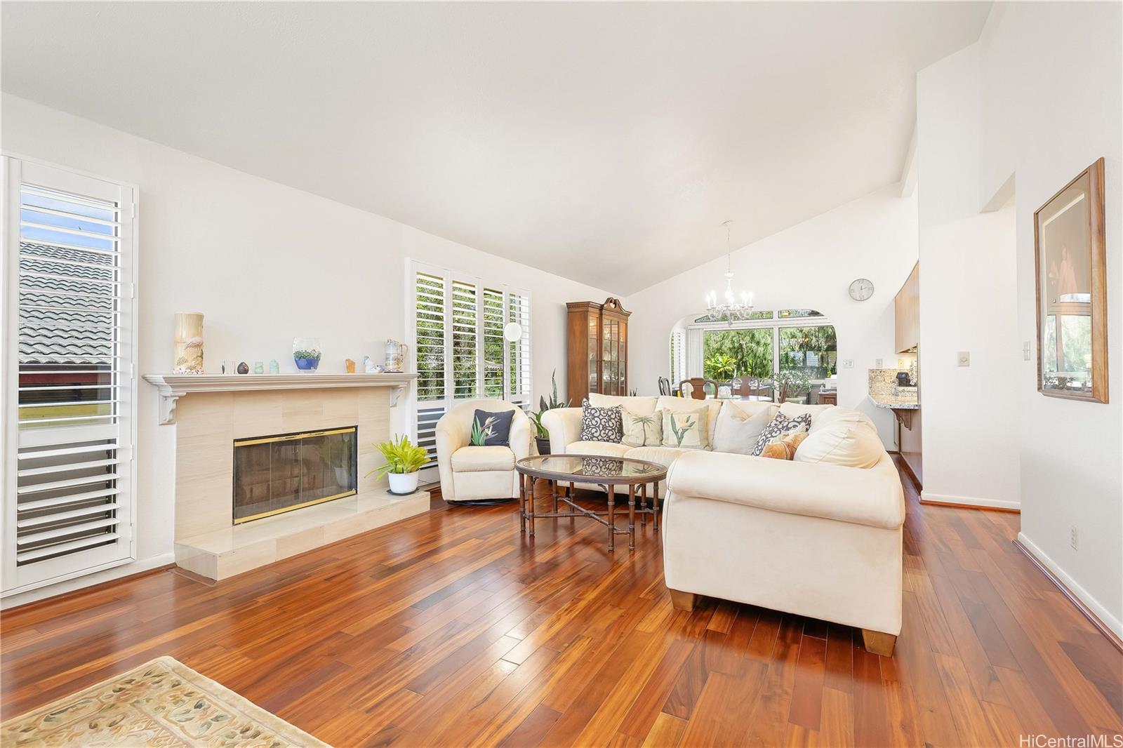 98-1421 Onikiniki Place, Unit 5 Aiea, HI 96701 - Photo 2 of 25 a living room with furniture and a fireplace