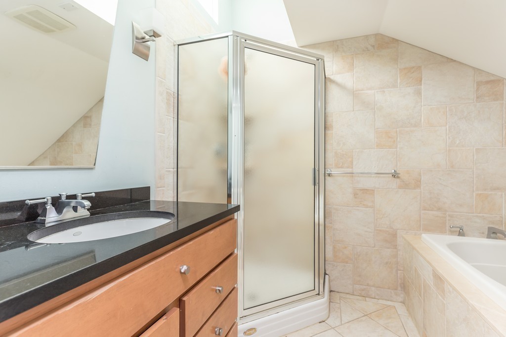 86 West Springfield Street, Unit 3 Boston, MA 02118 - Photo 10 of 12 a bathroom with a granite countertop sink mirror and shower