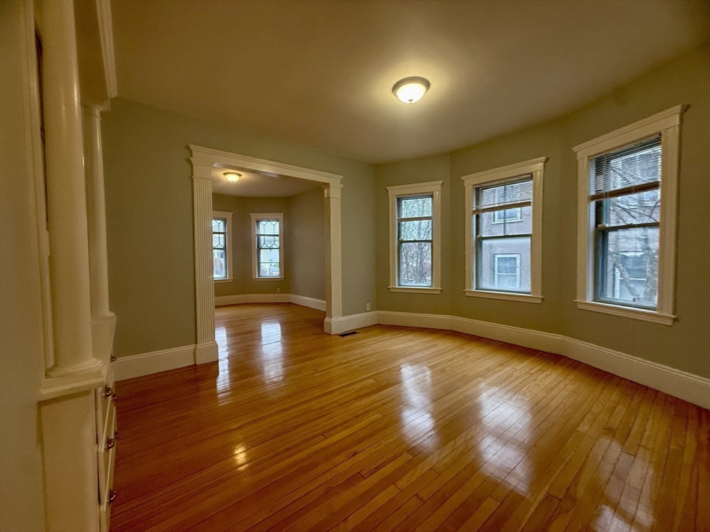 172 Maplewood Street, Unit 172 Watertown, MA 02472 - Photo 12 of 29 a view of empty room with wooden floor and fan