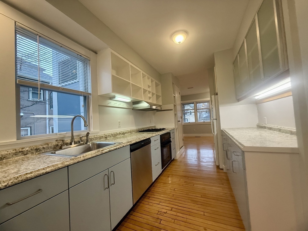 172 Maplewood Street, Unit 172 Watertown, MA 02472 - Photo 19 of 29 a kitchen with granite countertop a sink and cabinets