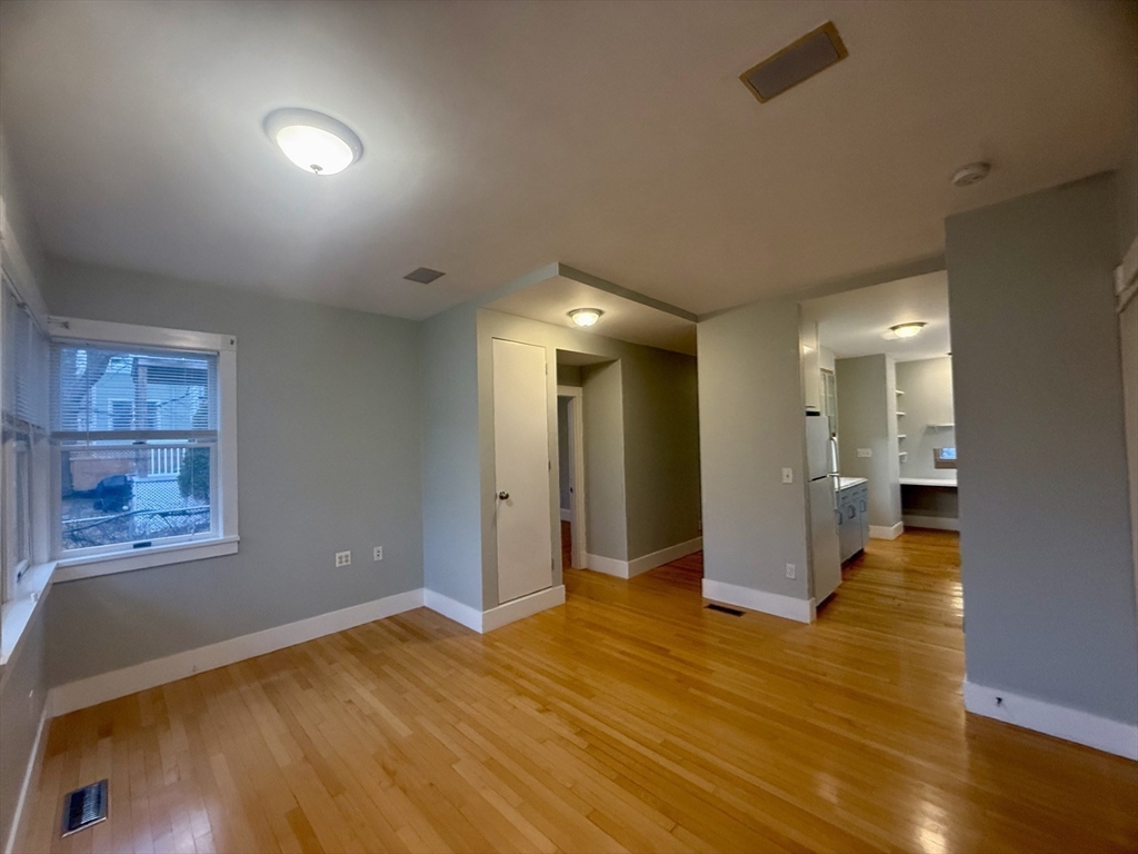 172 Maplewood Street, Unit 172 Watertown, MA 02472 - Photo 20 of 29 a view of an empty room and wooden floor