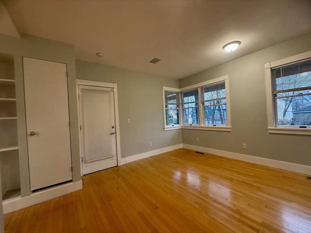 172 Maplewood Street, Unit 172 Watertown, MA 02472 - Photo 21 of 29 a view of an empty room with window and wooden floor