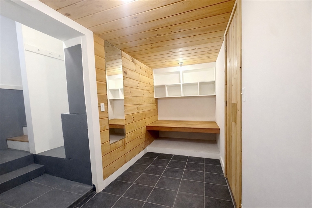 172 Maplewood Street, Unit 172 Watertown, MA 02472 - Photo 25 of 29 a bathroom with a glass door shower and a sink