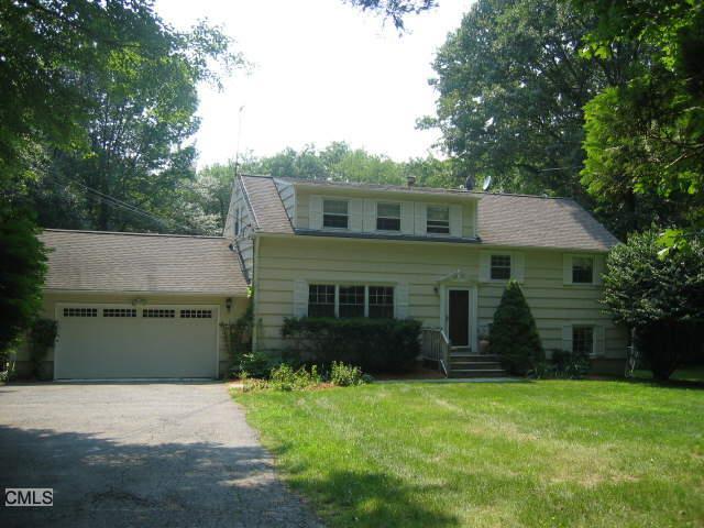 19 Ground Pine Road Wilton, CT 06897 - Photo 1 of 1 a front view of a house with a garden