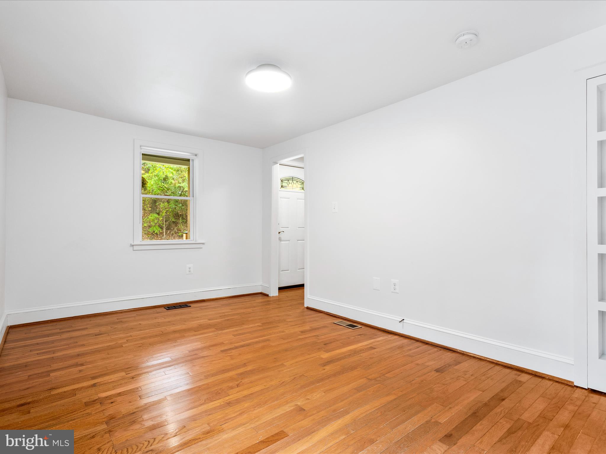 4417 Reels Mill Road Frederick, MD 21704 - Photo 11 of 64 an empty room with wooden floor and windows