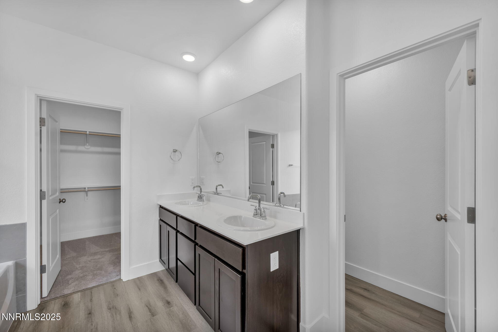 1333 Nebula Road, Unit HOMESITE 45 Carson City, NV 89705 - Photo 12 of 19 a bathroom with a sink a mirror and a shower