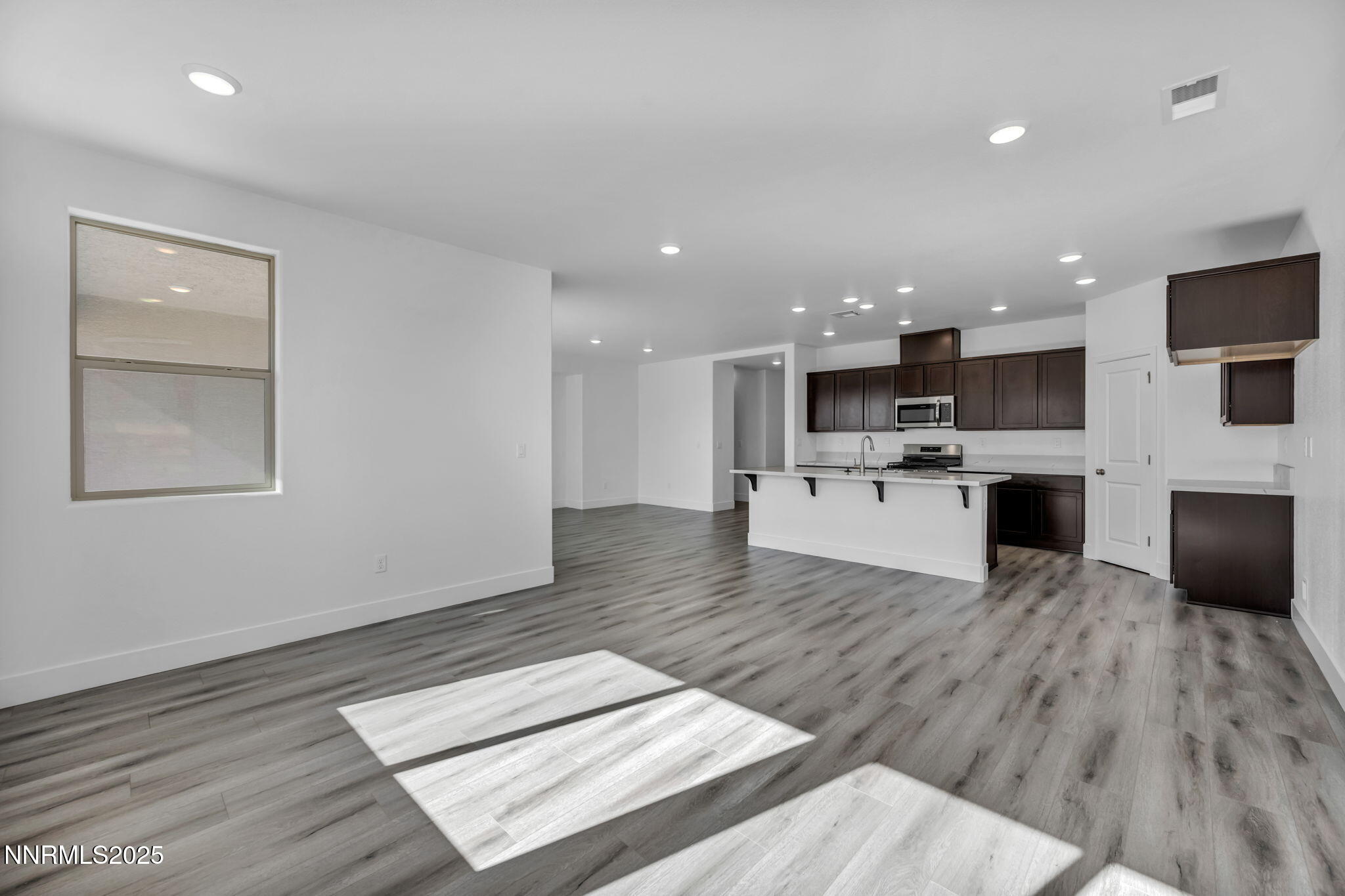 1333 Nebula Road, Unit HOMESITE 45 Carson City, NV 89705 - Photo 7 of 19 a living room with stainless steel appliances furniture wooden floor and a view of kitchen