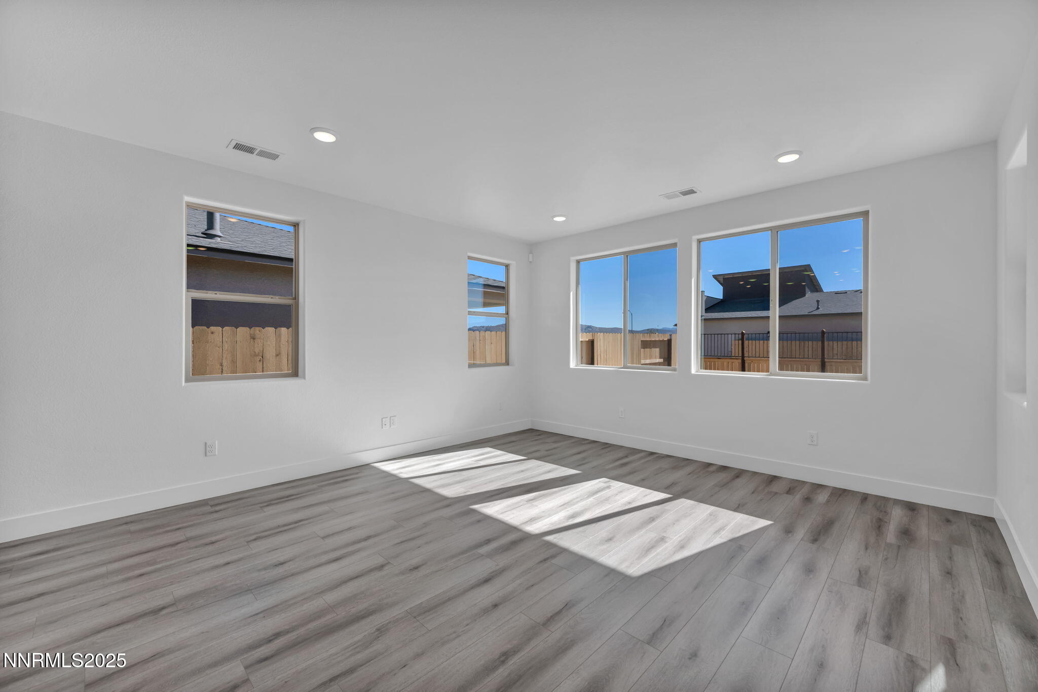 1333 Nebula Road, Unit HOMESITE 45 Carson City, NV 89705 - Photo 8 of 19 a view of an empty room with wooden floor and a window