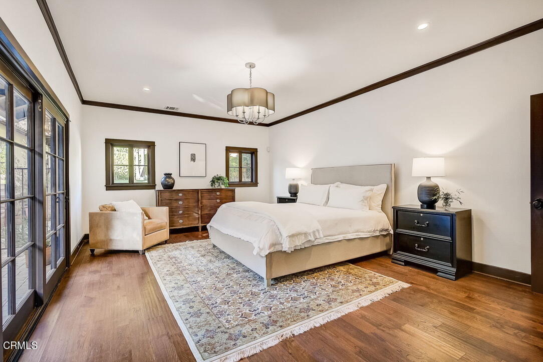 1717 East Mendocino Street Altadena, CA 91001 - Photo 34 of 68 a spacious bedroom with a bed couch chandelier and a window