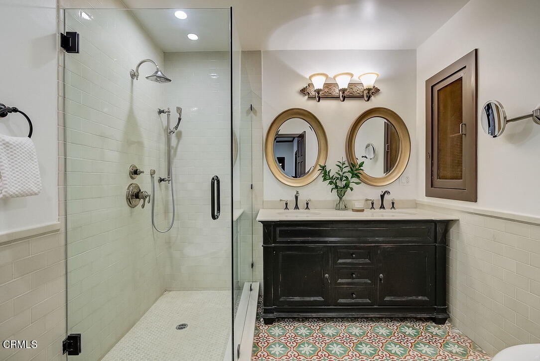 1717 East Mendocino Street Altadena, CA 91001 - Photo 35 of 68 a bathroom with a sink a mirror and a shower