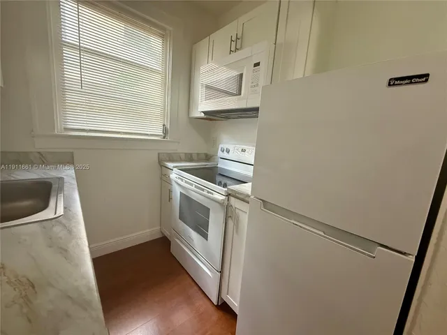 a view of a kitchen with sink washer and dryer