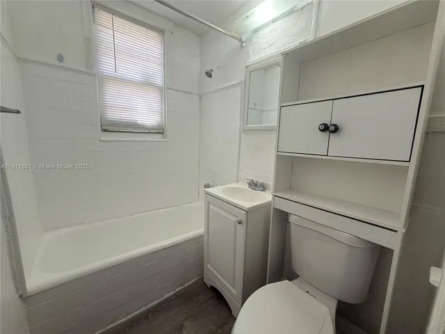 a bathroom with a sink a toilet and bathtub