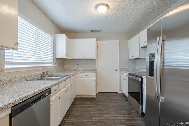 a kitchen with a sink stove and refrigerator