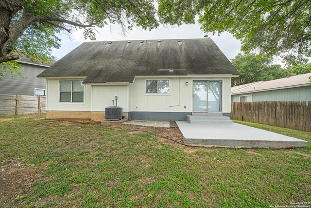 a backyard of house with a barbeque grill and plants