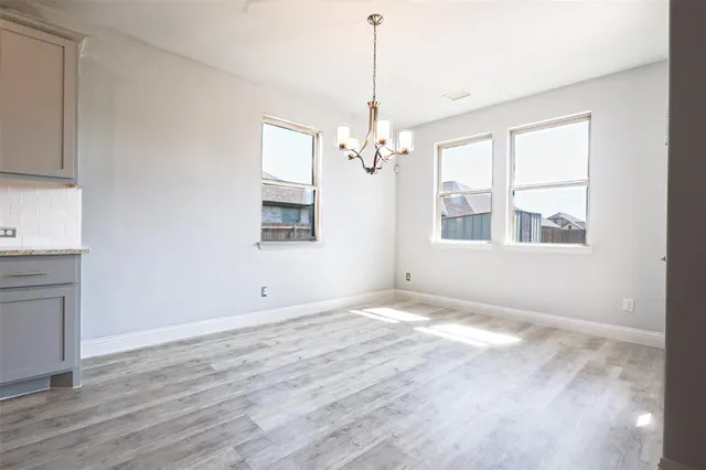 a view of a room with window and wooden floor