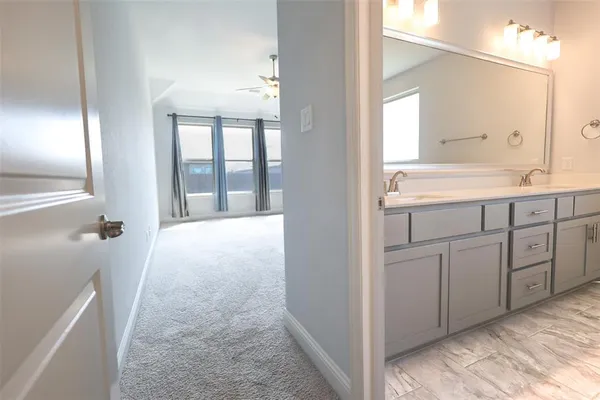 a view of a kitchen with white cabinets