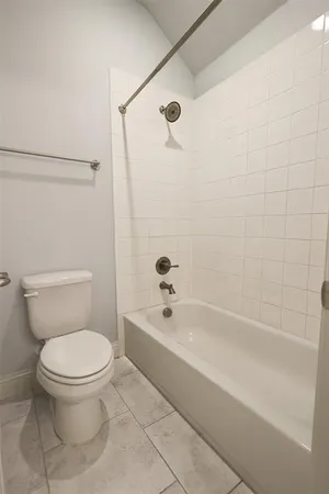 a bathroom with a toilet and a bathtub