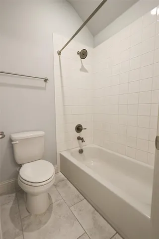 a bathroom with a toilet and a bathtub