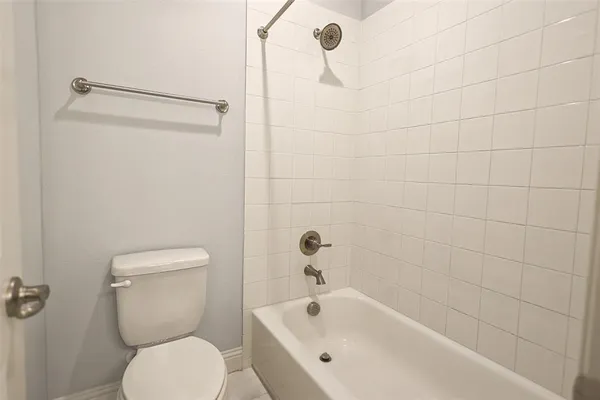 a bathroom with a toilet and bathtub