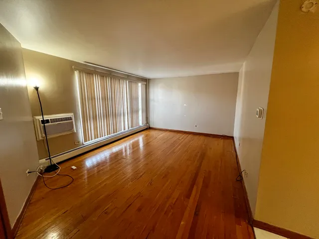a view of a room with wooden floor