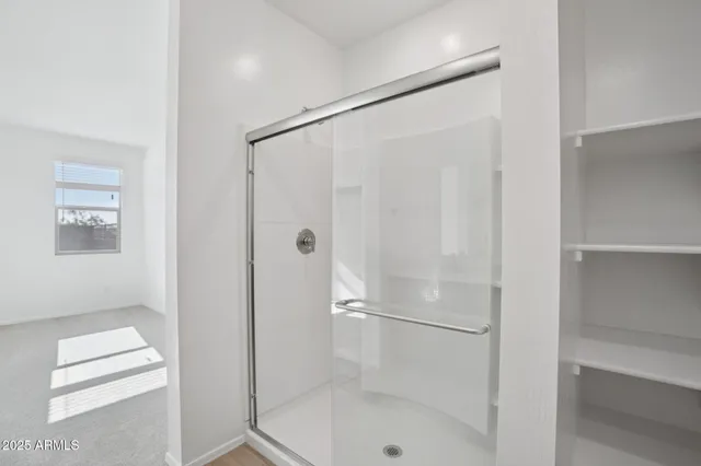 a bathroom with a glass shower door