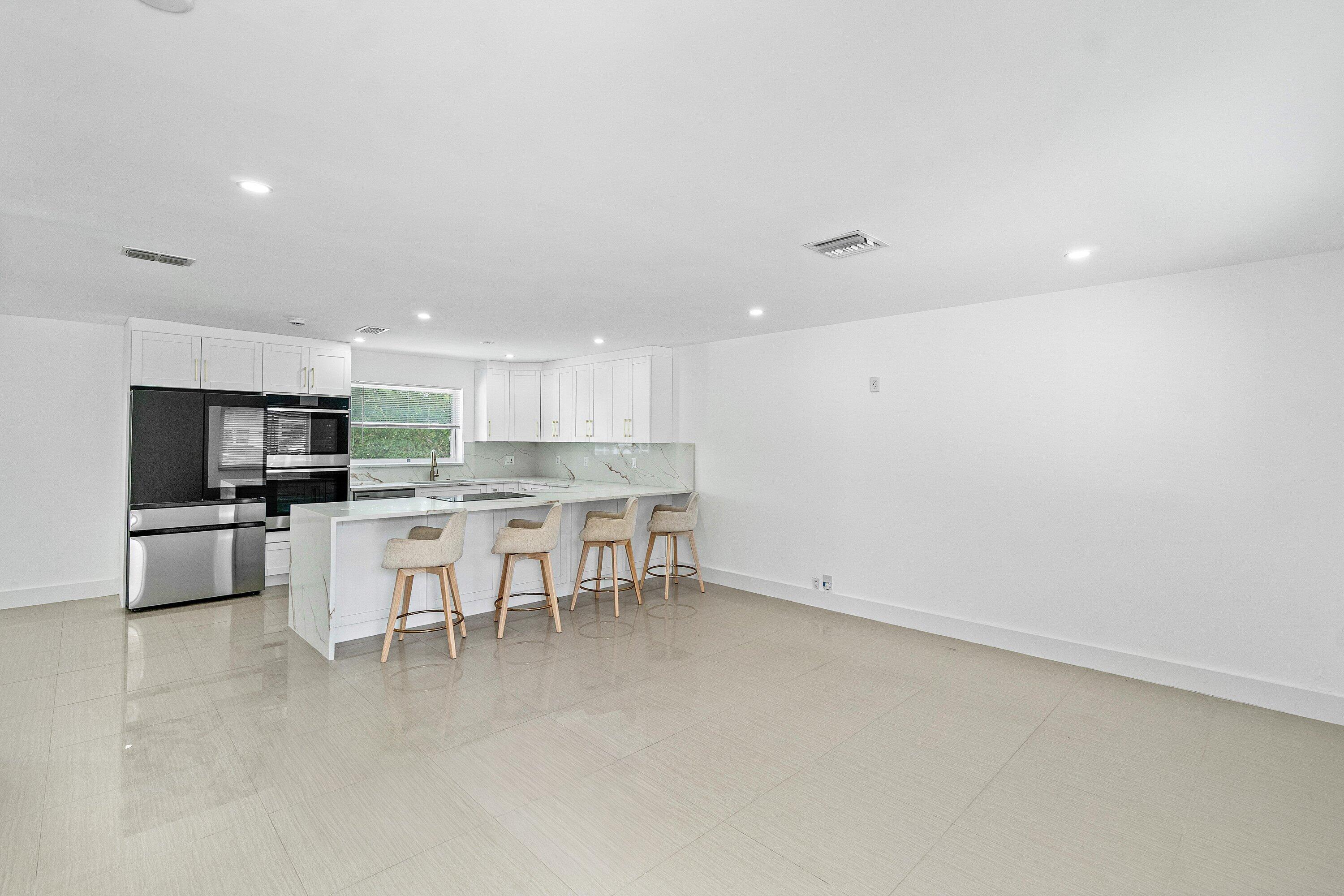 1531 Northwest 4th Street Boca Raton, FL 33486 - Photo 2 of 34 a view of kitchen with sink refrigerator and cabinets