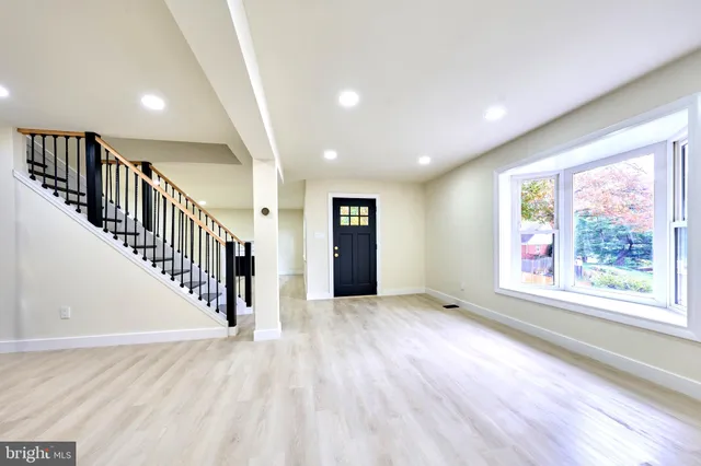 a large kitchen with kitchen island a sink stainless steel appliances and cabinets