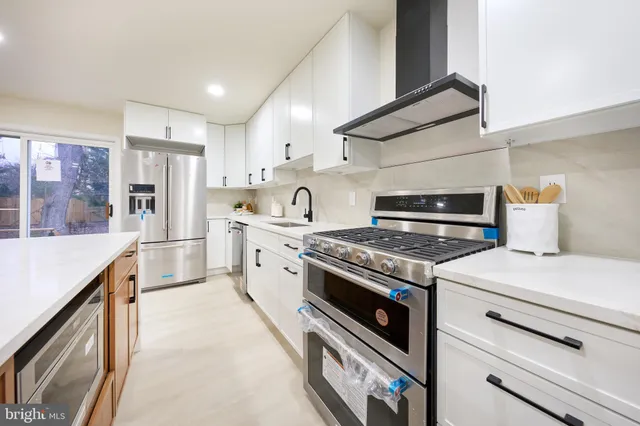 a bathroom with a white tub a window and a shower