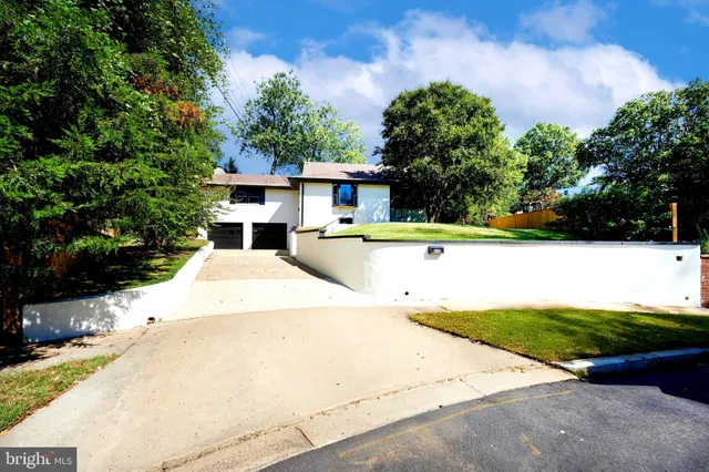 a front view of a house with a yard fire pit and outdoor seating