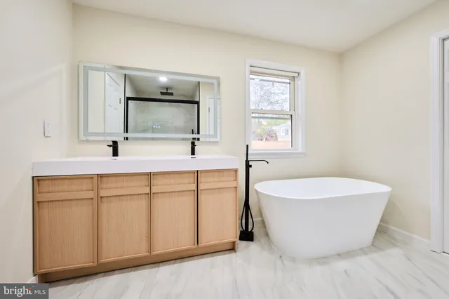 a kitchen with white cabinets a sink and dishwasher